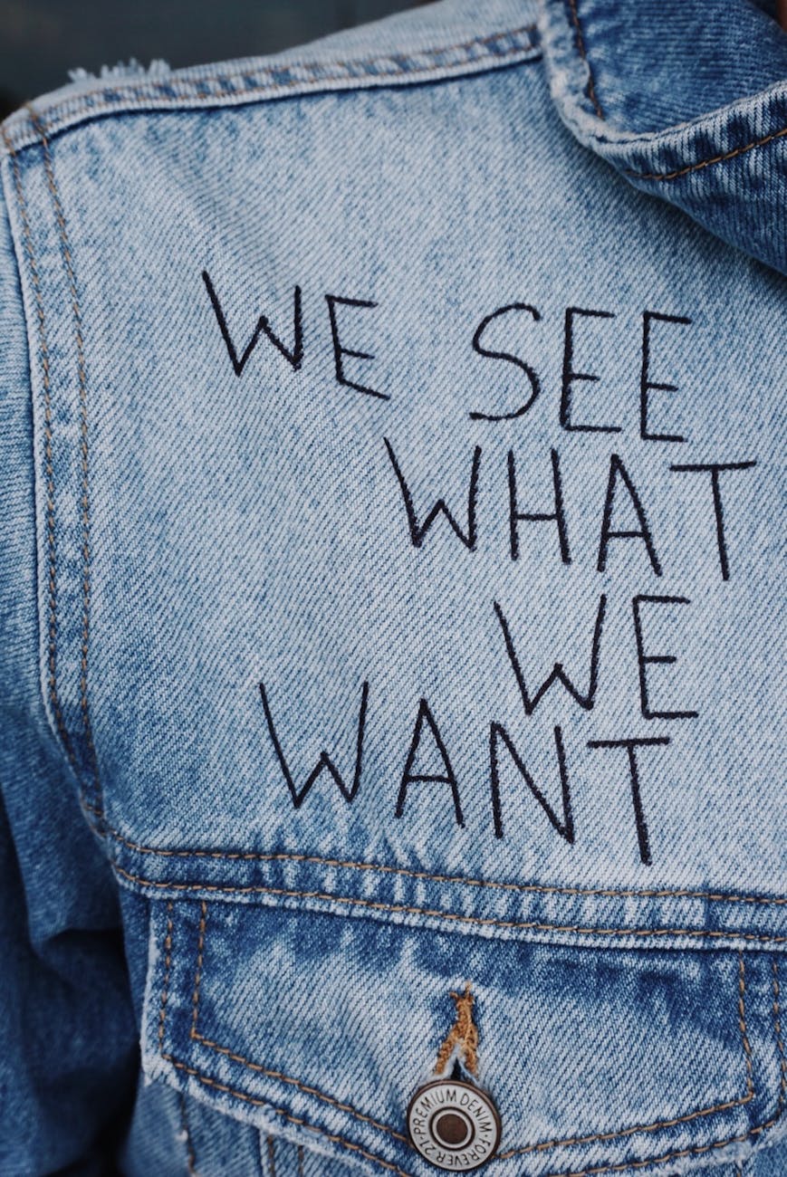 blue denim collared top with we see what we want text overlay